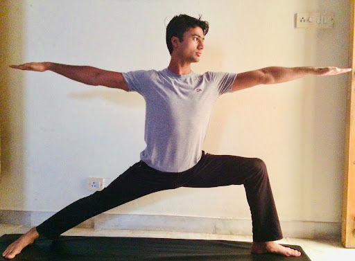 Pradip Sharma performing Warrior Pose (Virabhadrasana) in calm studio lighting